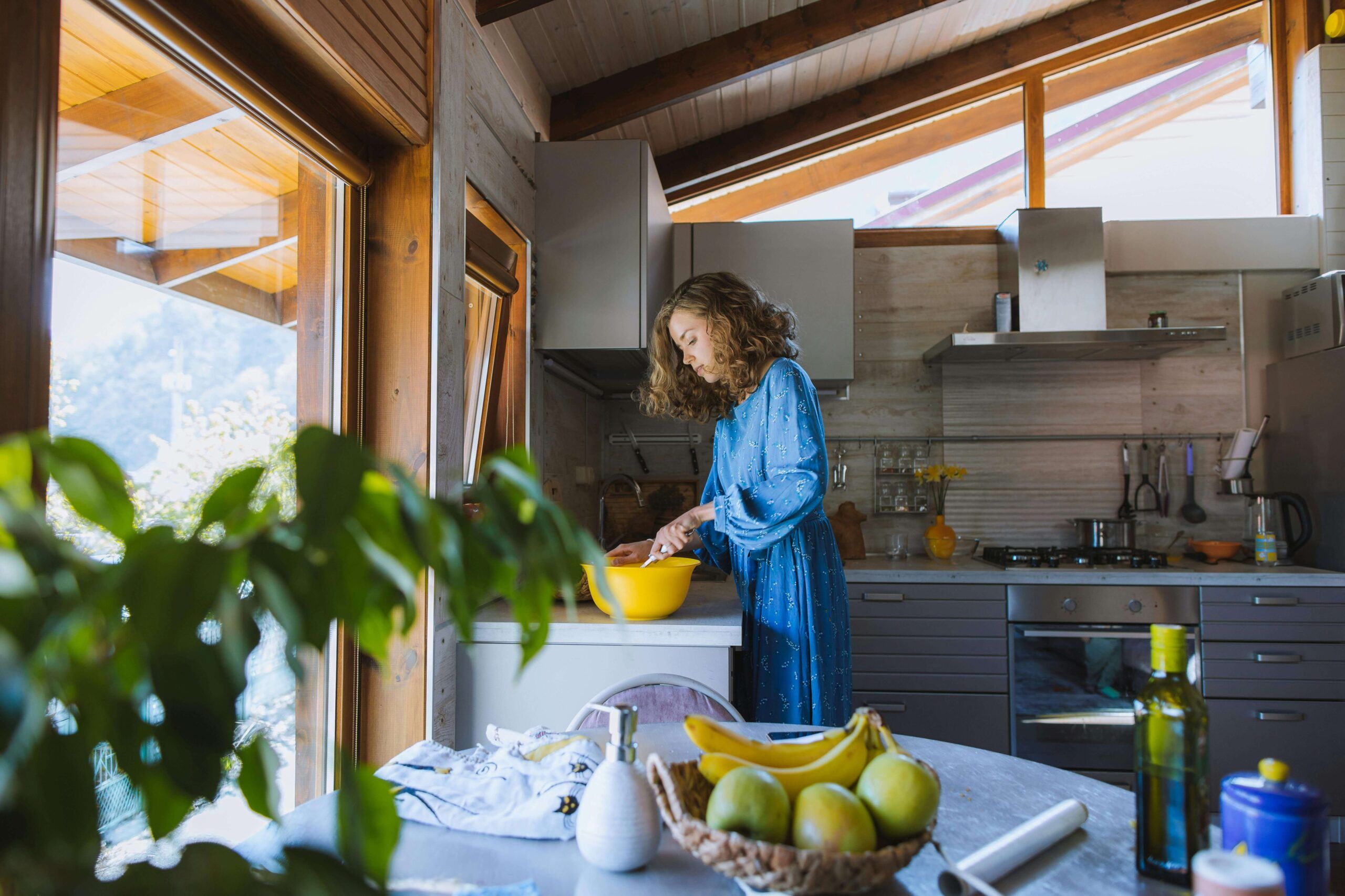 A woman prepares a meal in a bright kitchen, emphasizing mindful eating and balanced nutrition. Learn about nutritional counseling in Raleigh, NC, and support from a nutritionist in Asheville, NC for personalized wellness guidance.