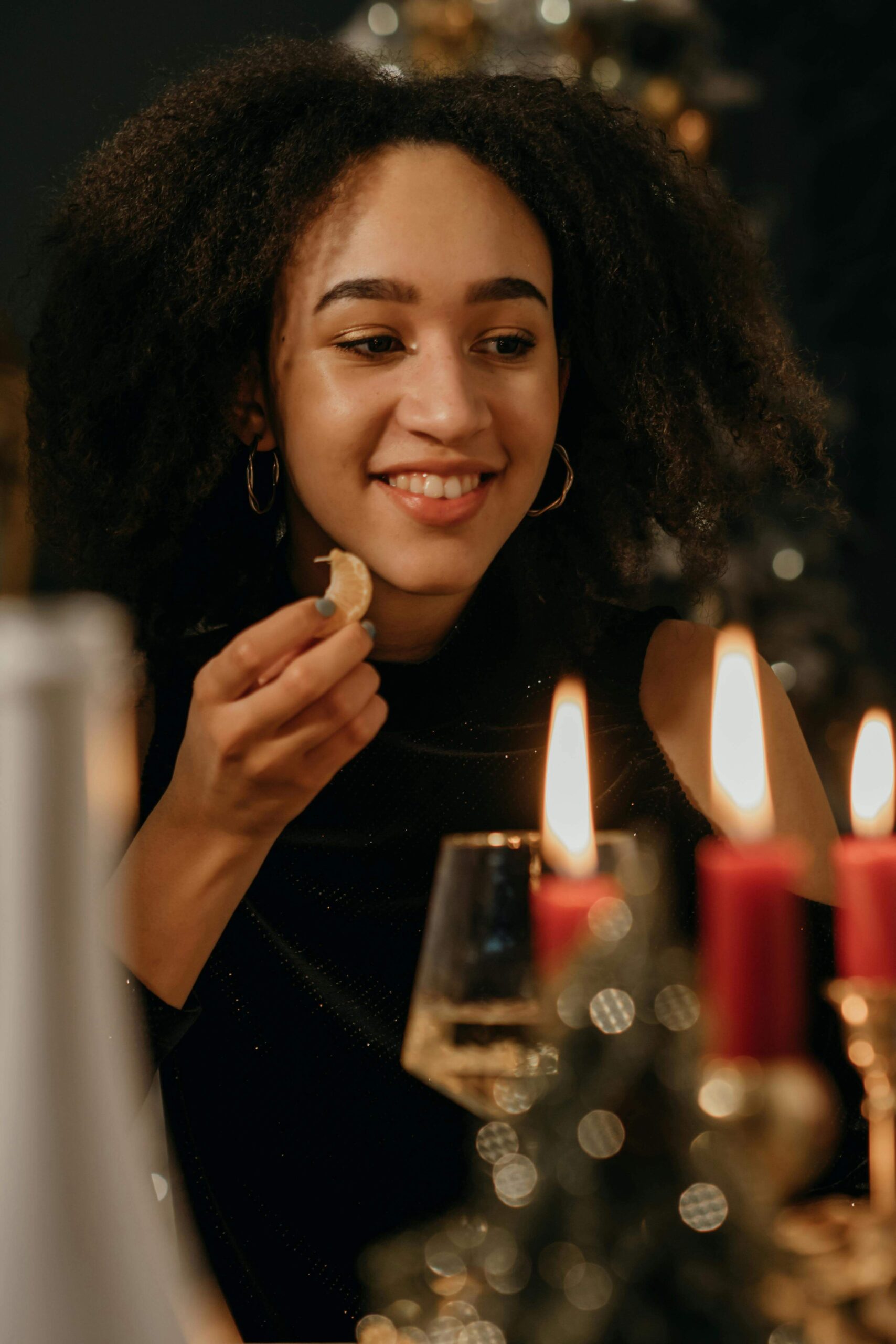 A woman smiles while tasting food at a holiday table. Can positive sensory moments during the holidays support emotional balance? Nutrition counseling in Raleigh, NC, can help build mindful, supportive eating experiences for sensory-sensitive individuals.