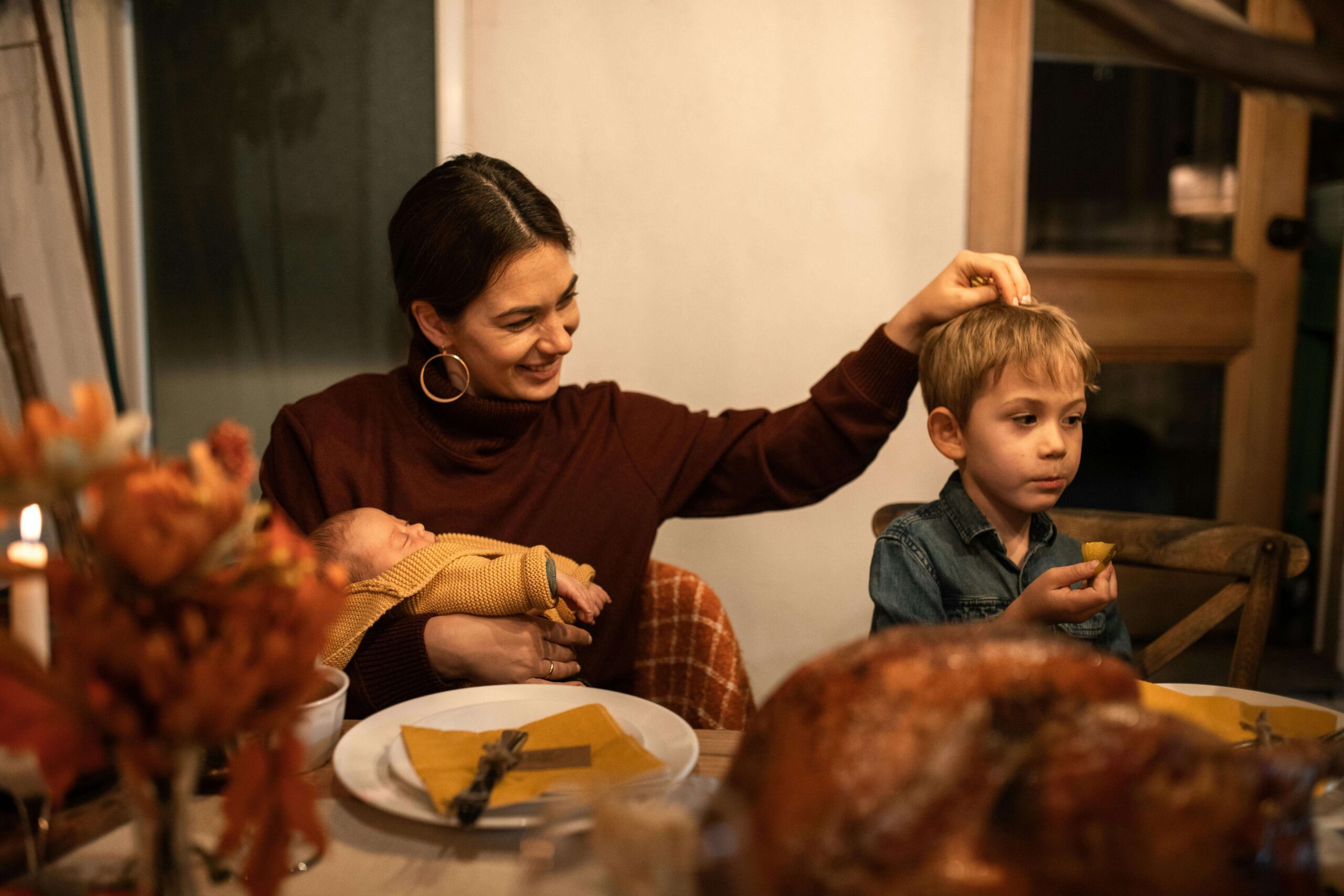 A parent comforts children during a busy holiday meal filled with sights, sounds, and new foods. What happens when sensory processing disorder turns family gatherings into emotional overload? A registered dietitian in Raleigh, NC, can help families adjust holiday meals to better support sensitive kids.