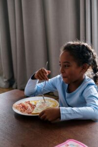 Child eating breakfast with support from nutrition education and counseling in Raleigh and nutritional therapist Raleigh, NC for ARFID treatment without pressure to expand foods